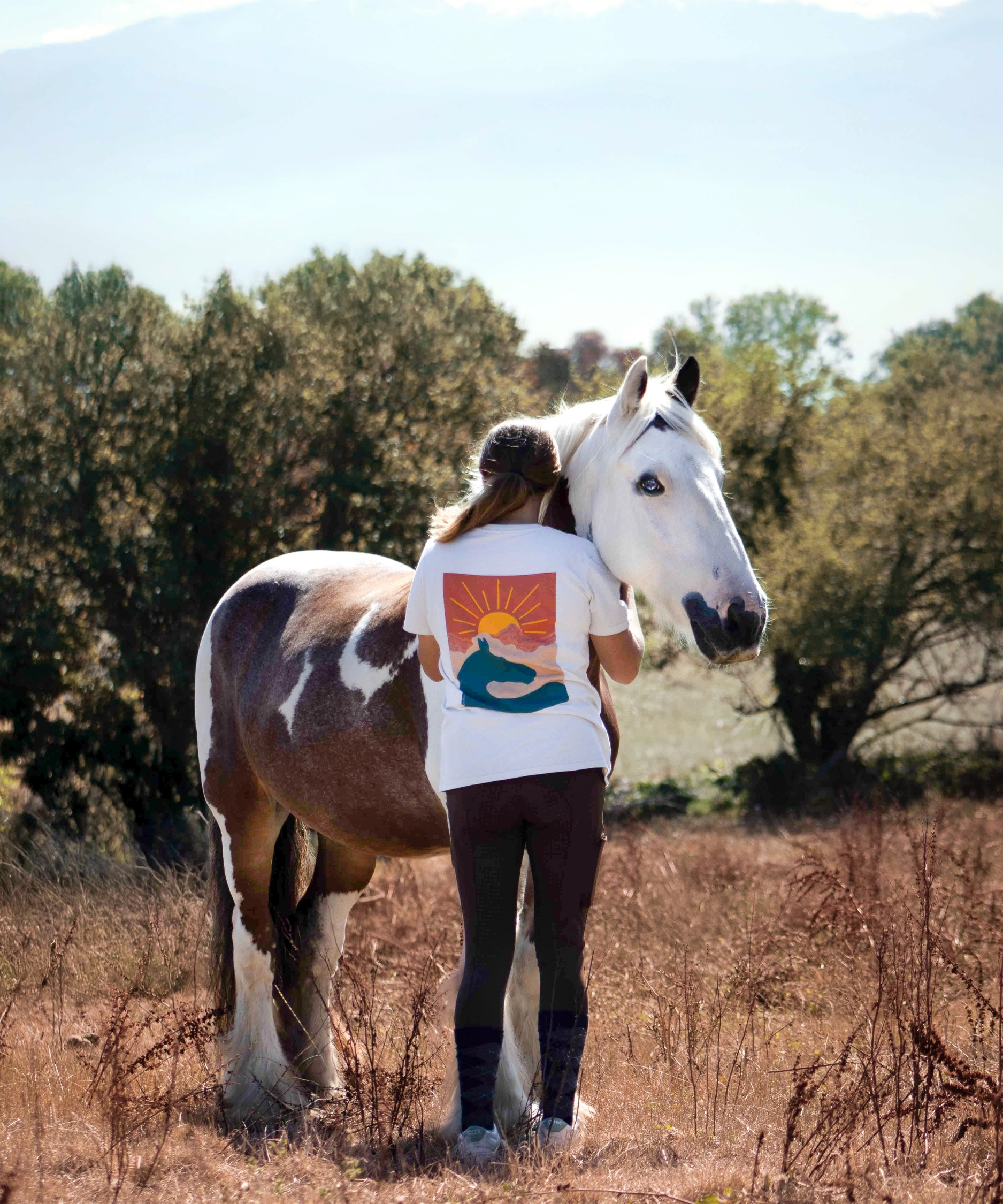 cheval pie photographié avec sa cavalière dans un t-shirt équestre engagé en coton bio
